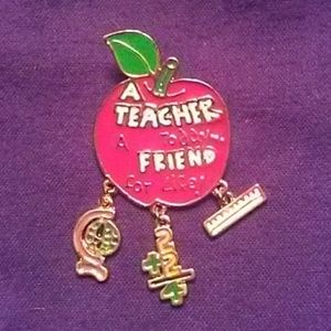 A vintage signed pin for a teacher award.